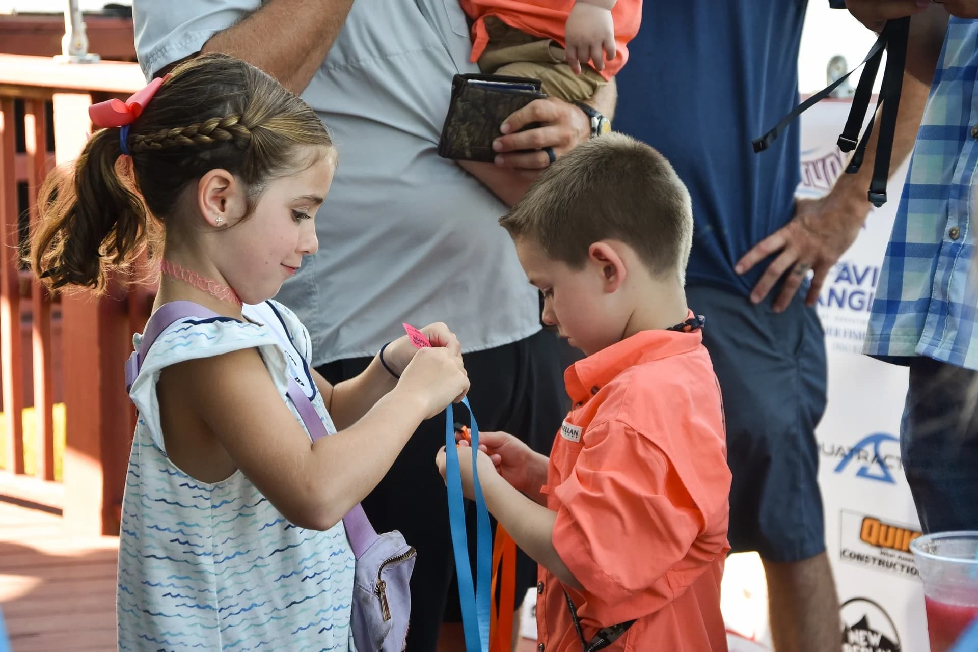 Two young anglers admiring their ribbons at the Kids Kingfish Derby awards ceremony