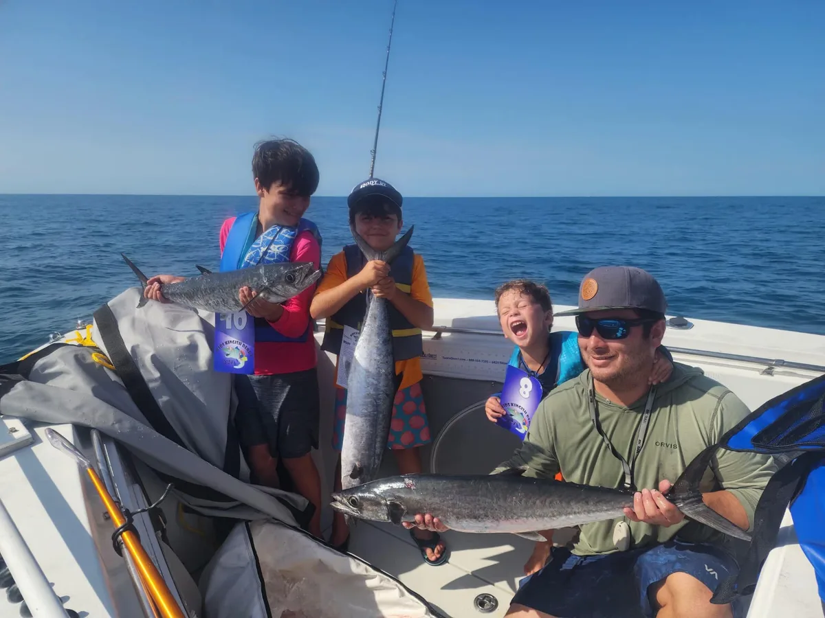 Young anglers and their captain on the water at the Kids Kingfish Derby